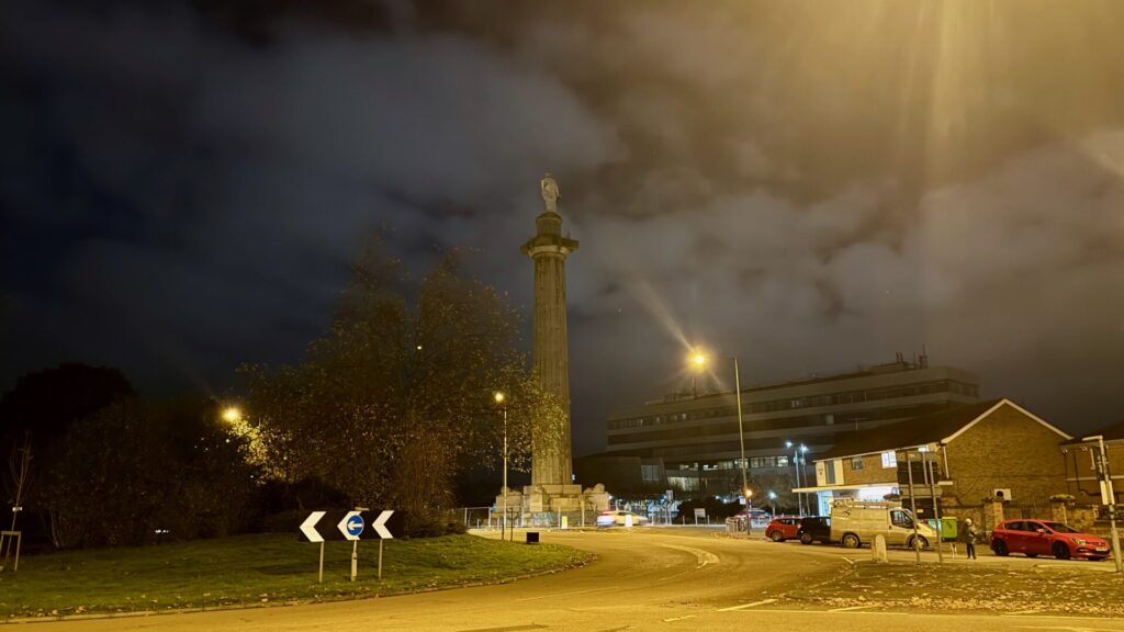 A nighttime photograph of Lord Hill's column in Shrewsbury and the roundabout in front of it with no cars circulating.